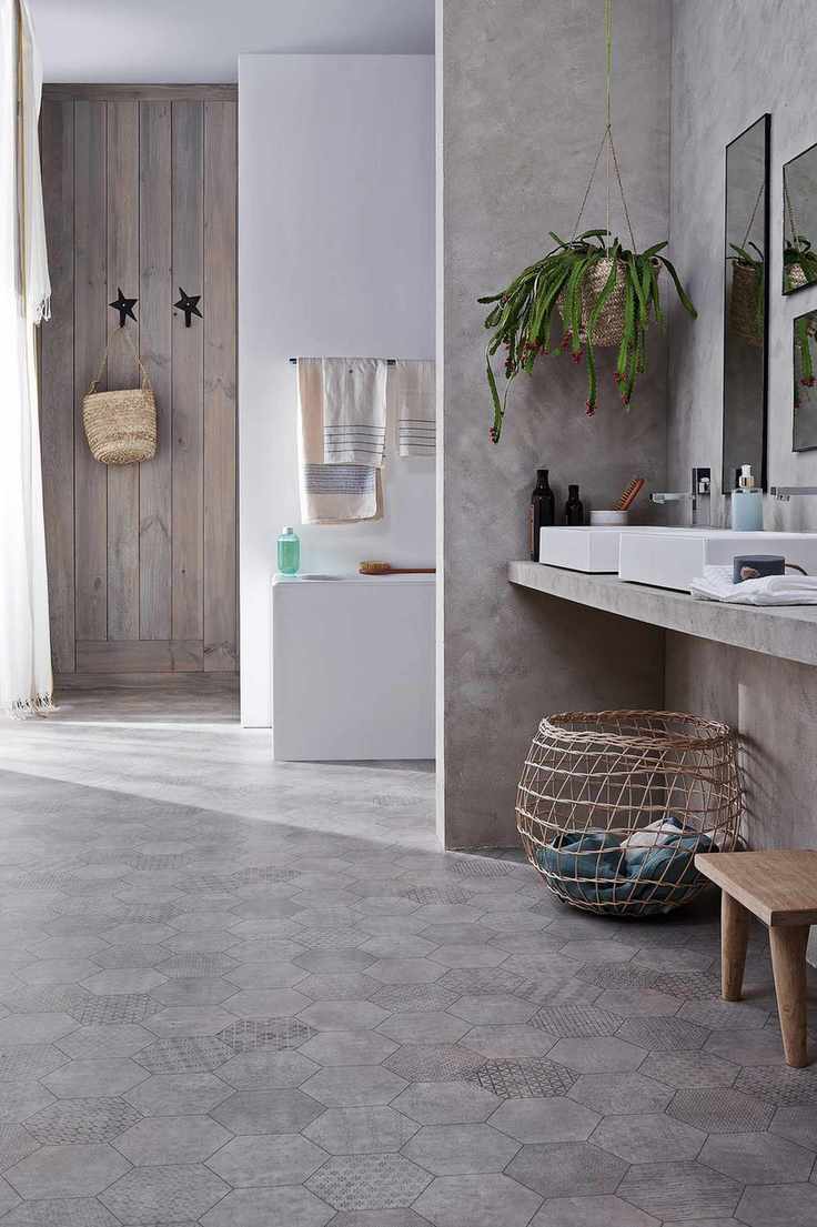 neutral bathroom with vinyl patterned flooring, double basins, bath in background