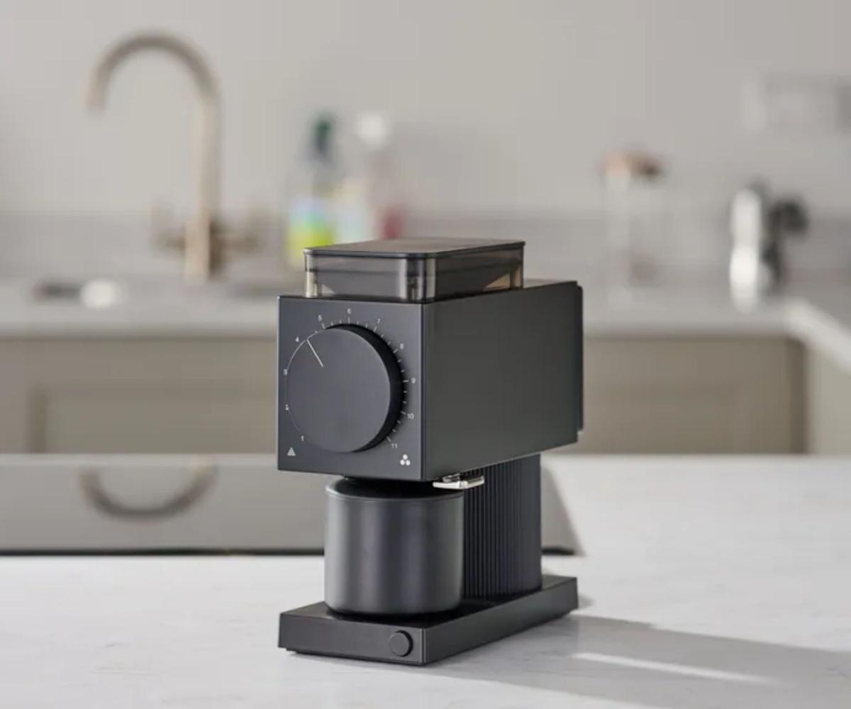 A small black blocky coffee grinder on a white kitchen counter.