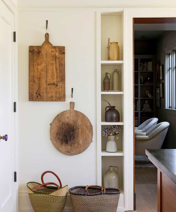 A kitchen corner painted in Swiss Coffee, featuring wooden floors and displays.