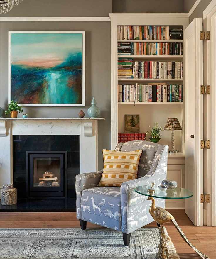 A sitting room with Portland Stone walls, featuring a wood-burning stove and colorful furnishings.