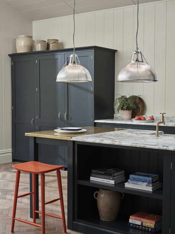 Tall blue kitchen cabinet with vases stored on top