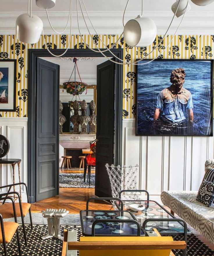 wallpapered entryway with art and sculptures and daring decor