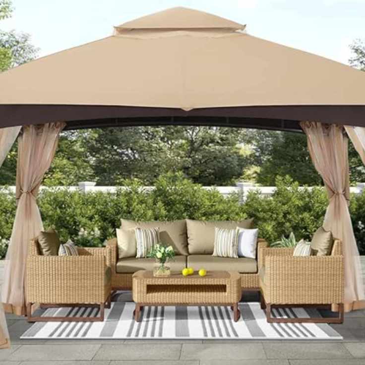 Beige canopy tent over garden furniture