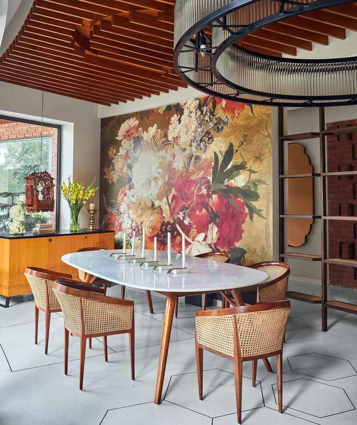 Modern, vibrant dining room with wooden chairs and flowers on display