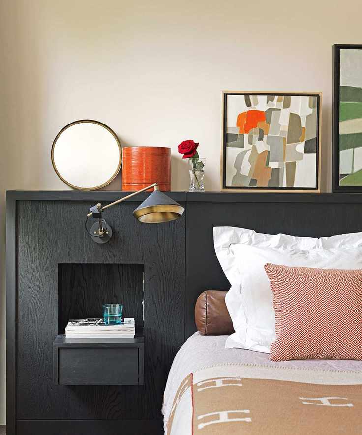 Contemporary bedroom with built-in storage and stylish wall lamp