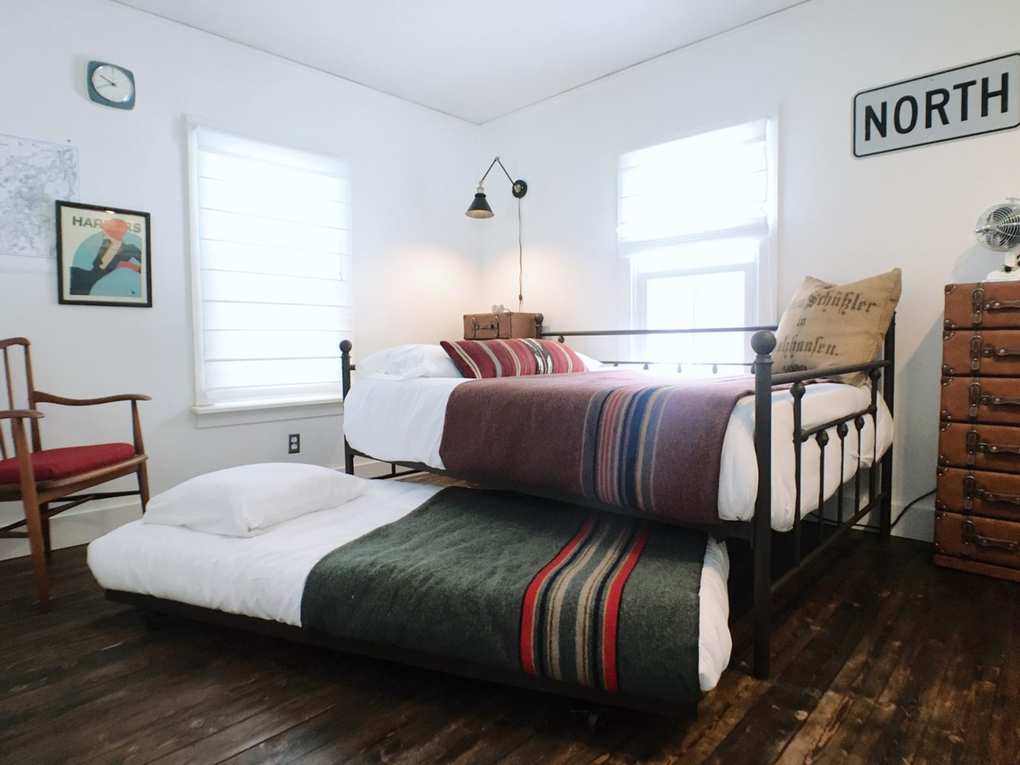 cabin bedroom with trundle beds and camp blankets