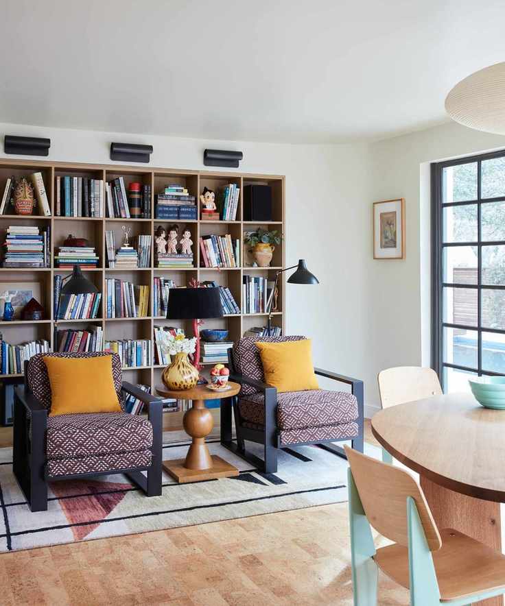 Bright room with large bookshelves and cozy seating.