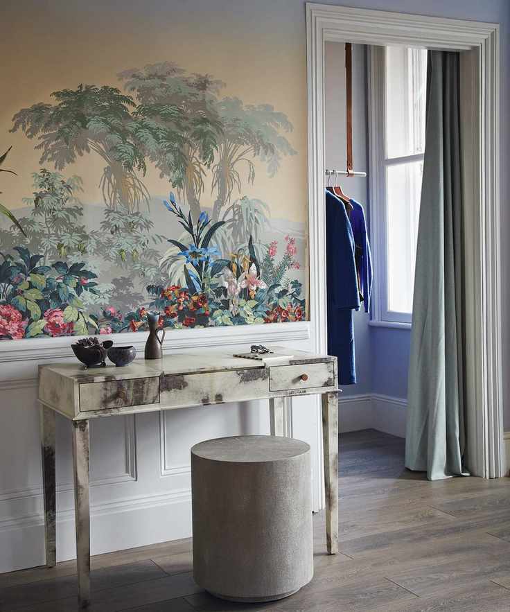 A marble dressing table backed by tropical wallpaper