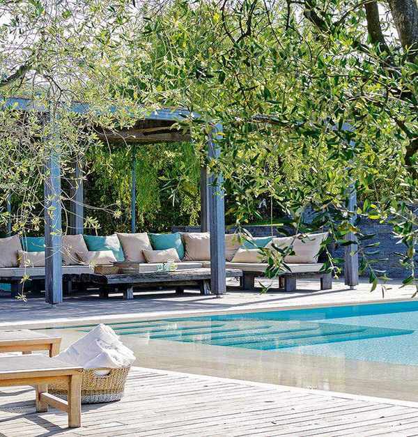 pergola seating area next to a pool