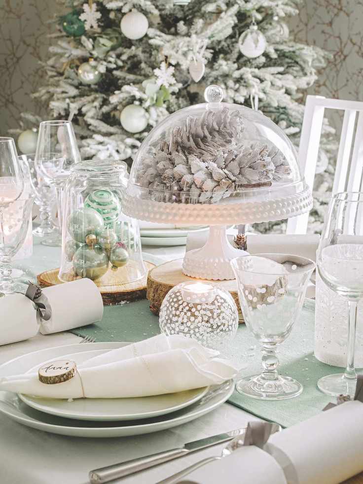 White painted pine cones under cake dome