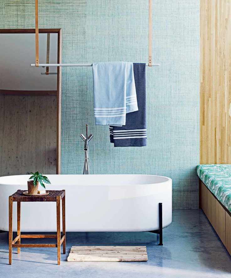 Bathroom with ceiling-mounted towel rail