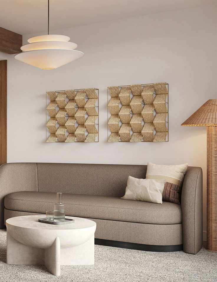 Curved West Elm sleeper sofa styled in an art-filled living room