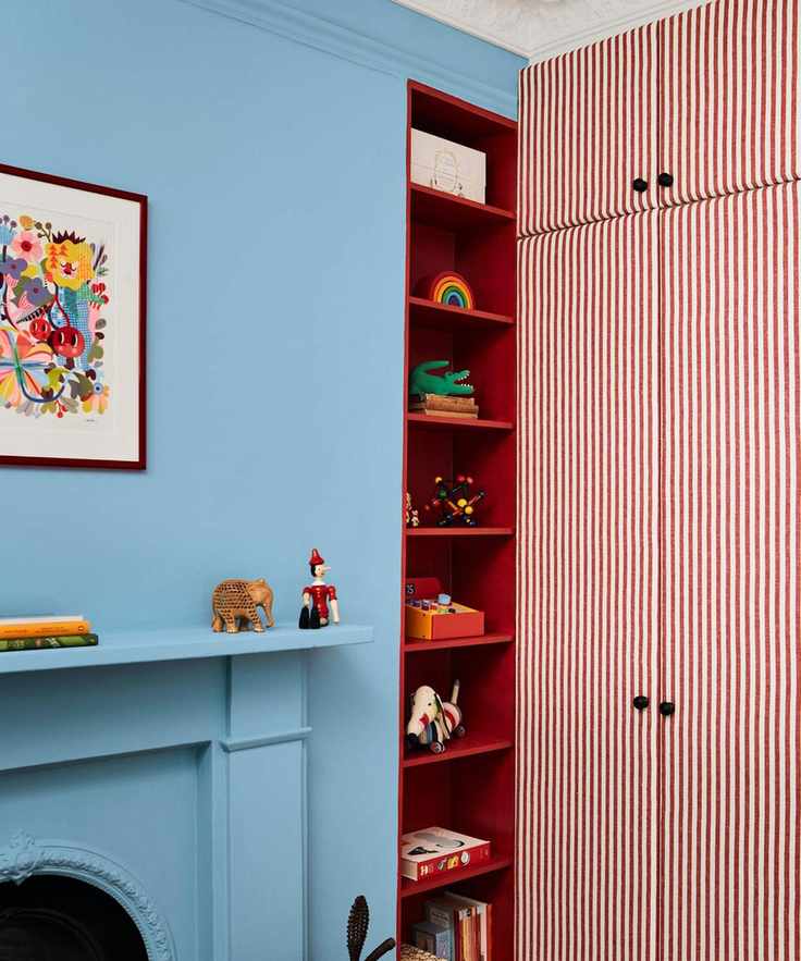 blue playroom bedroom with red wardrobes and shelving