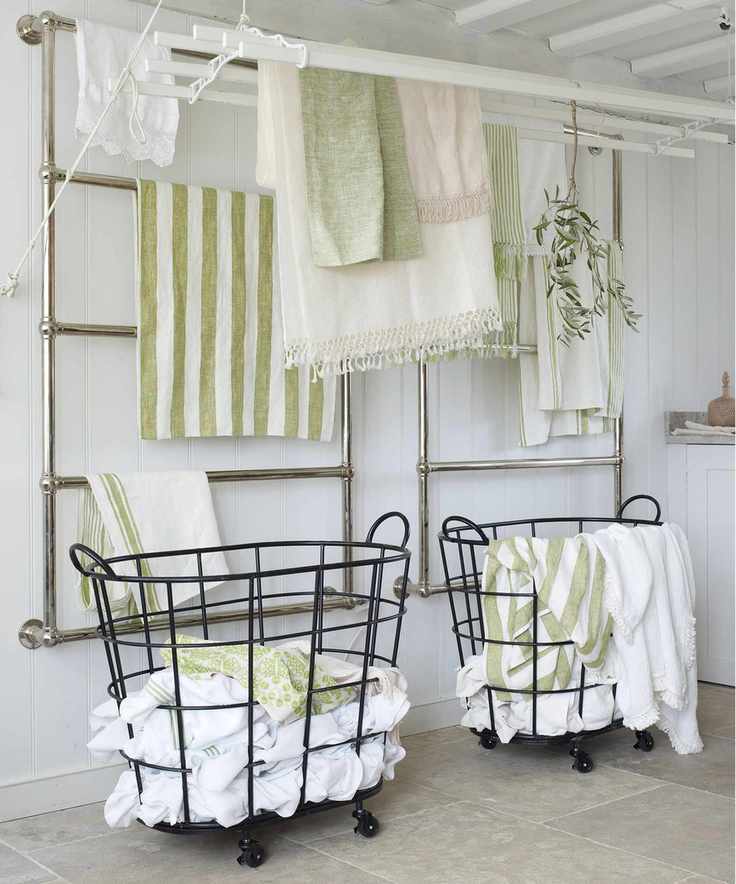 Laundry area with wall-mounted drying racks and green accents.