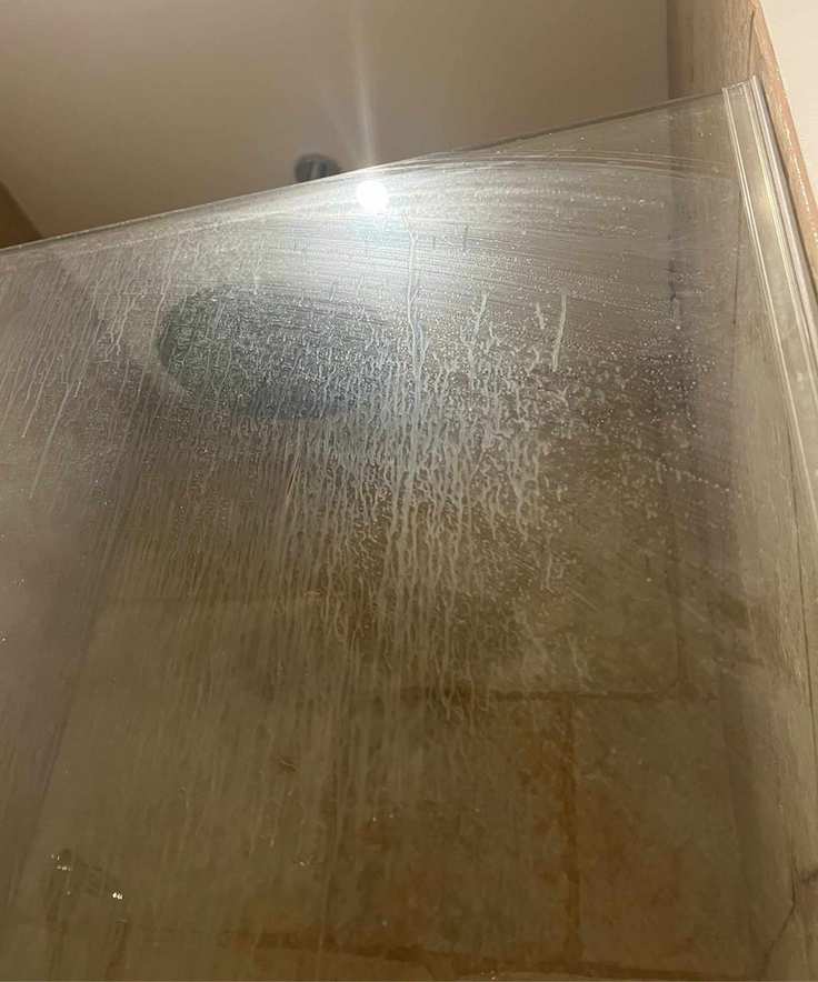 A streaked and smudged shower screen