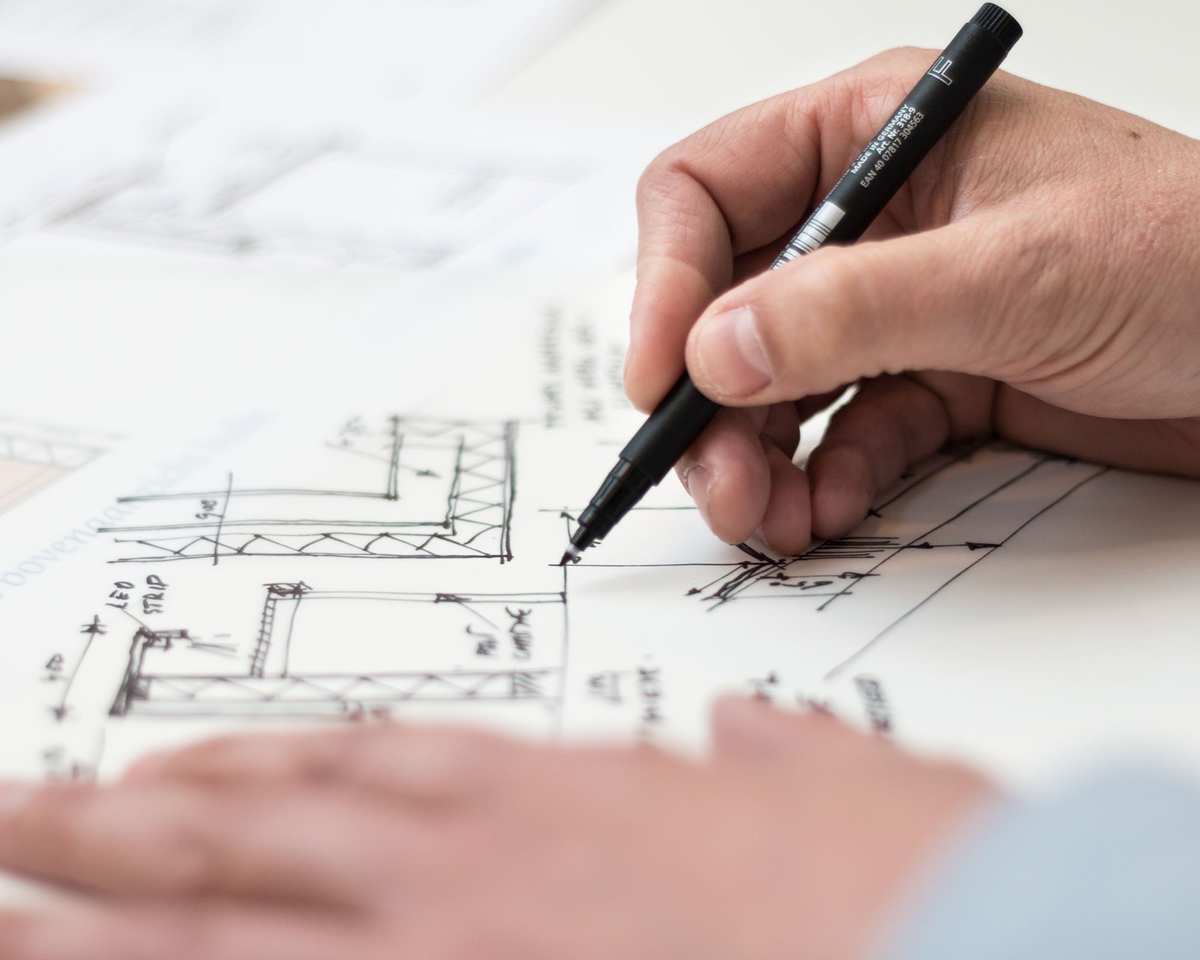 Someone drawing out a room plan