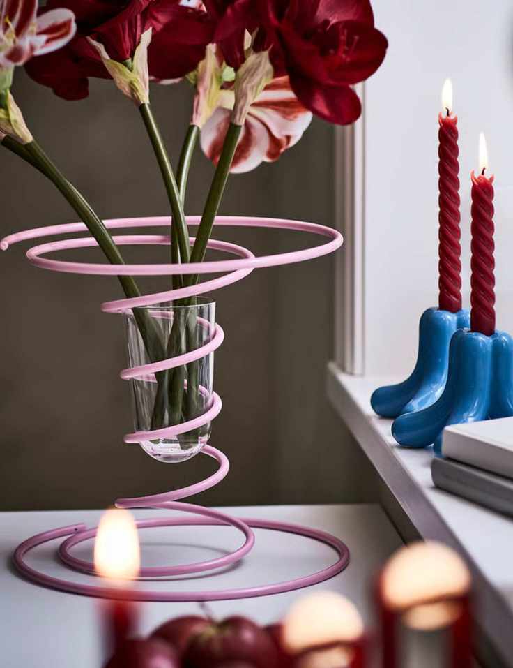 Eclectic table setting with Rebel Pink vase and blue taper holders