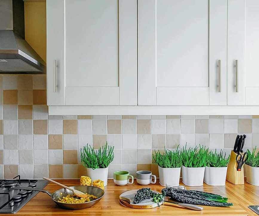 A white walmart kitchen with chrome hardware and wooden countertops