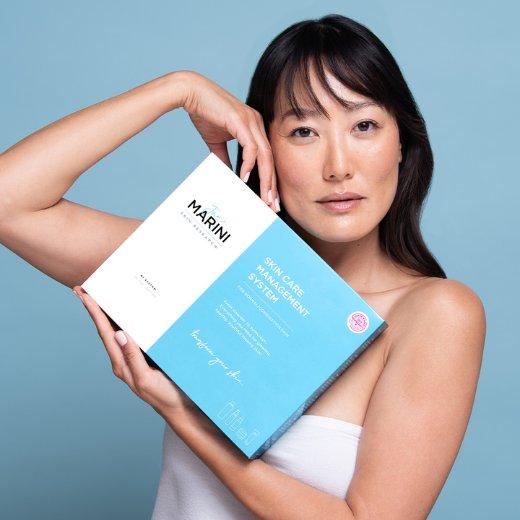 Jan Marini Skin Care Management System box held by model Jan Marini Skin Care Management System box held by model