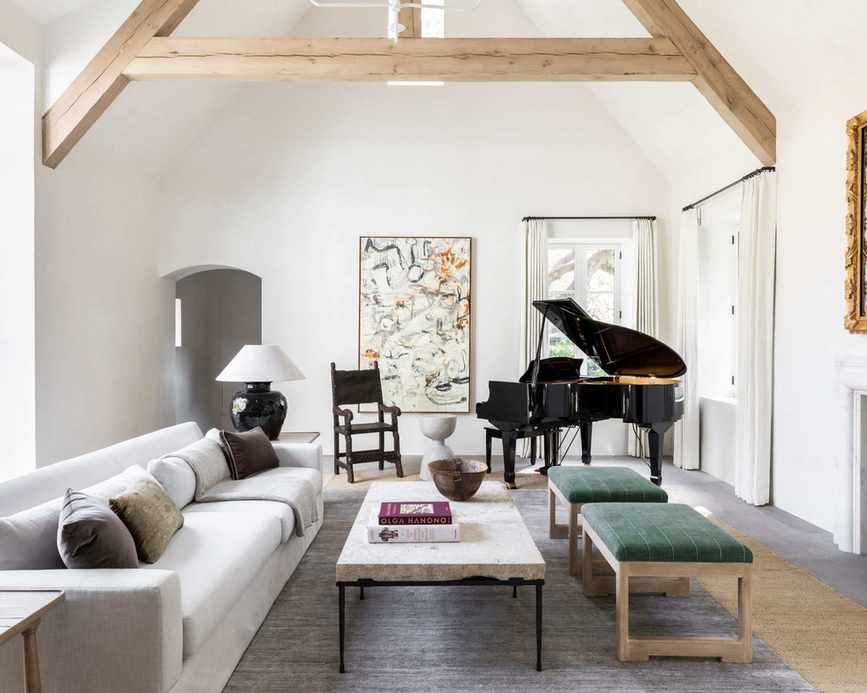 white living room with wood ceiling beams