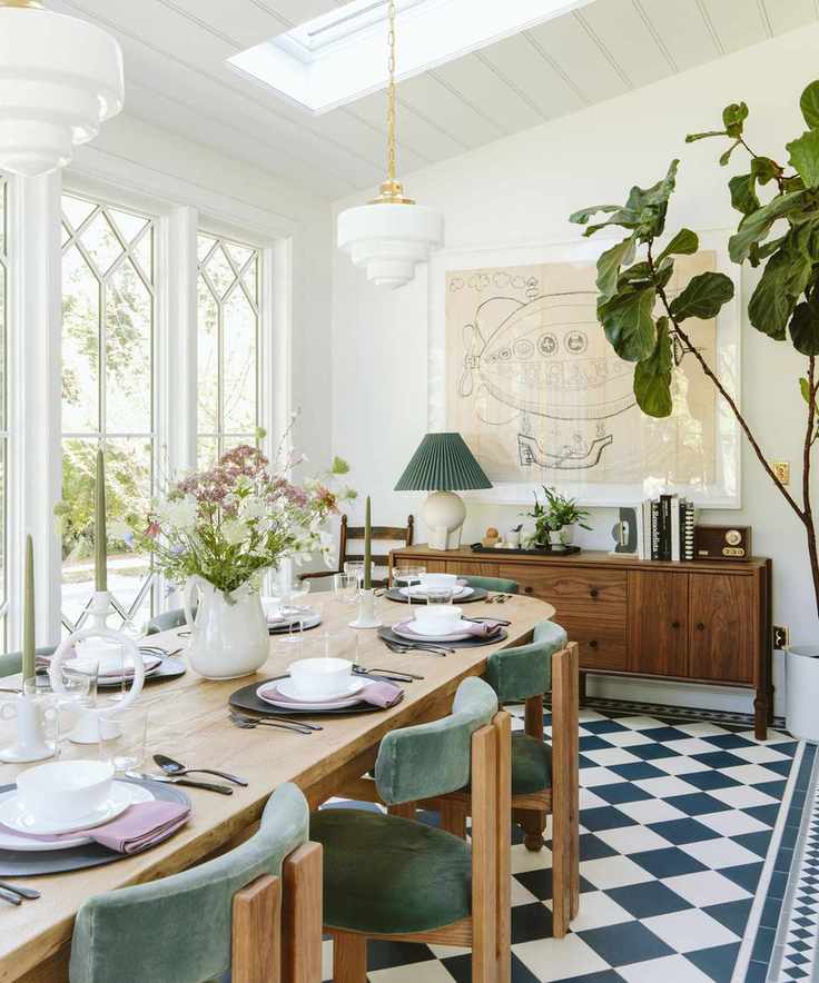 sunroom dining room with checkerboard flooring and large table