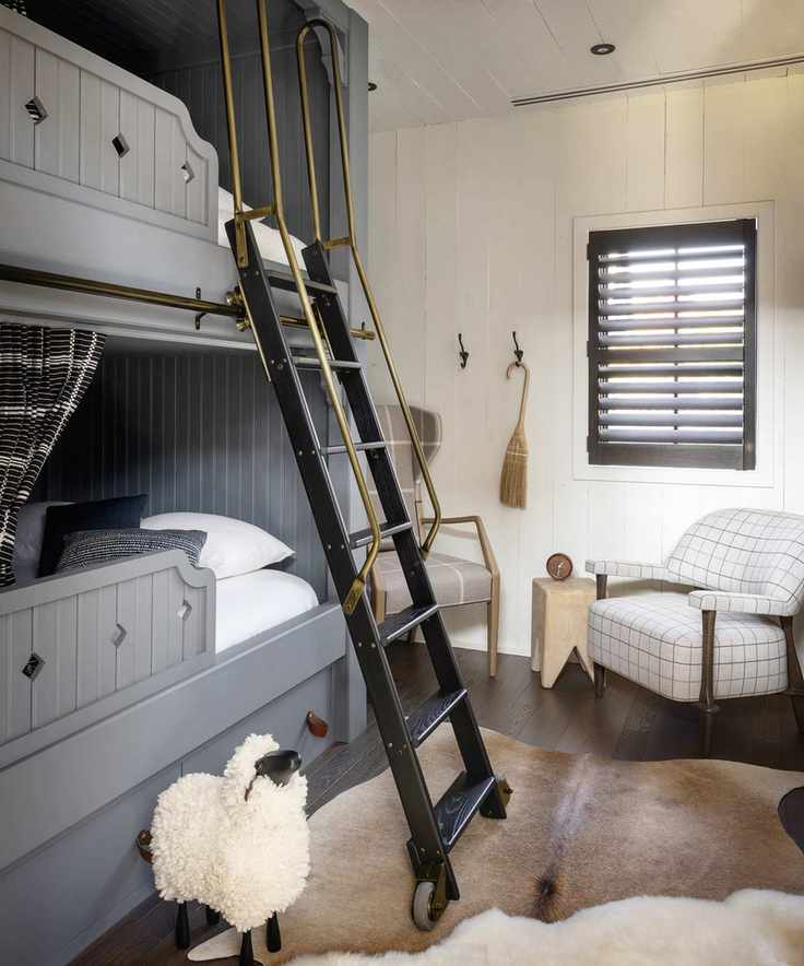 A stylish bedroom showcasing gray double bunk loft beds and a decorative sheep statue