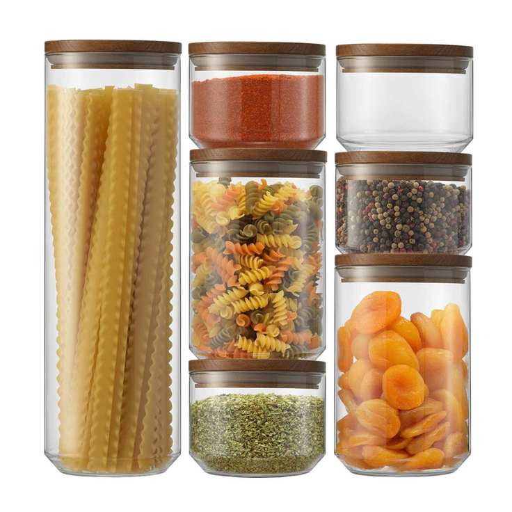 7 piece mixed size glass cannister pantry storage set with acacia lids stacks on top of each other