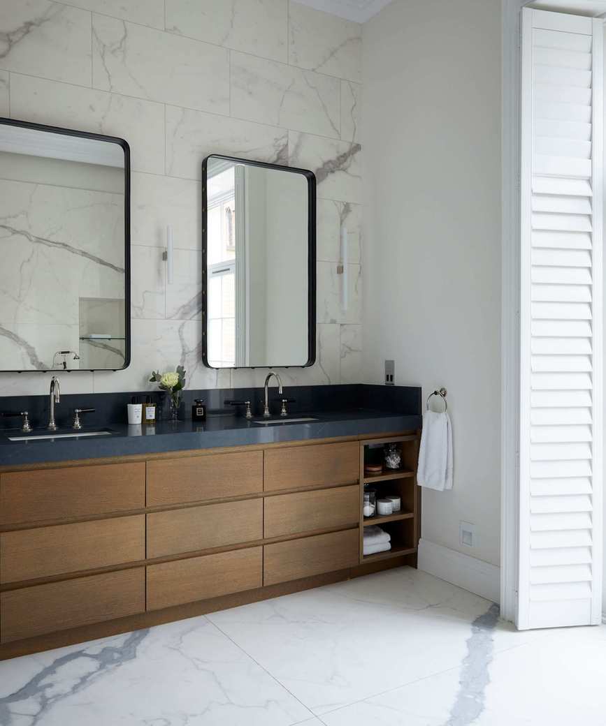 An example of bathroom storage ideas showing a bathroom with a wooden vanity unit in a Georgian townhouse in London