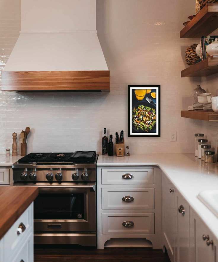 shaker style kitchen with wooden finishes and a digital photo frame on the wall