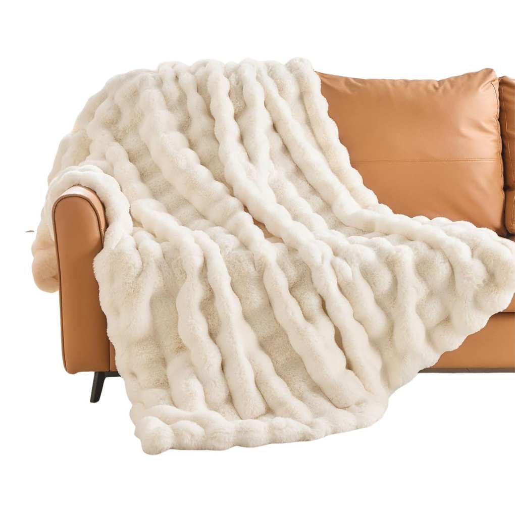 Fluffy white throw on a tan leather sofa