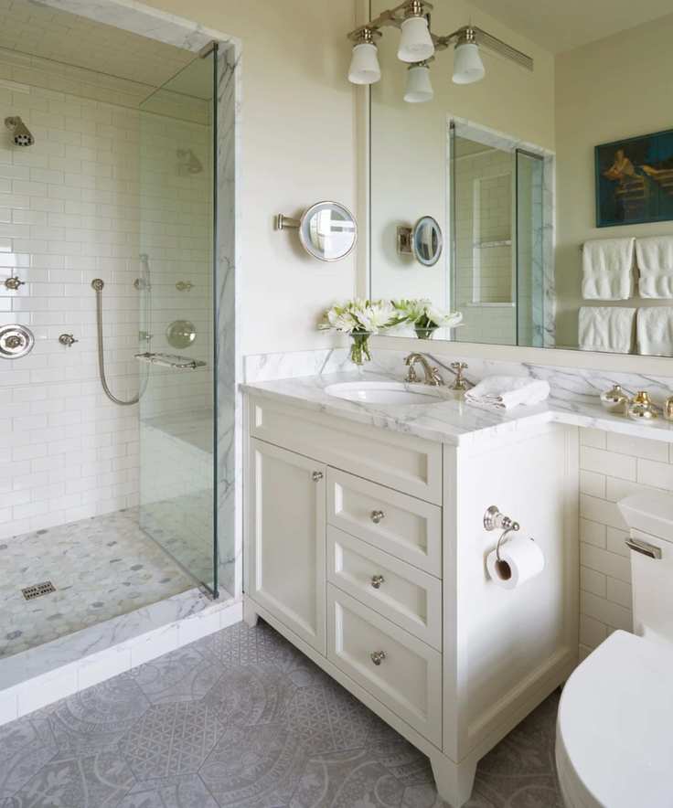 A bathroom with walk-in shower by Melichar Architects