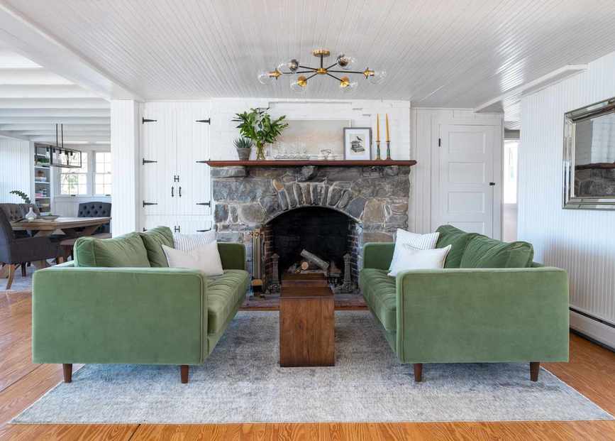 Living room highlighting green sofas and a fireplace