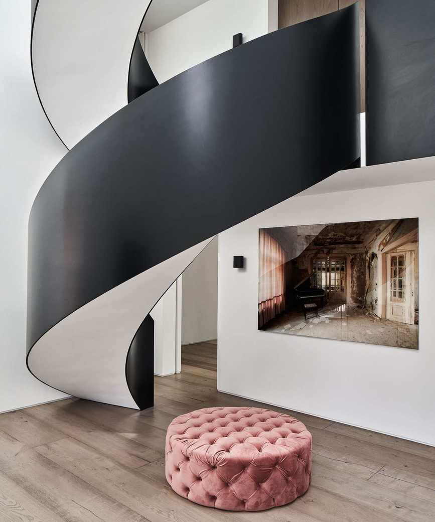 Modern entryway featuring a black spiral staircase