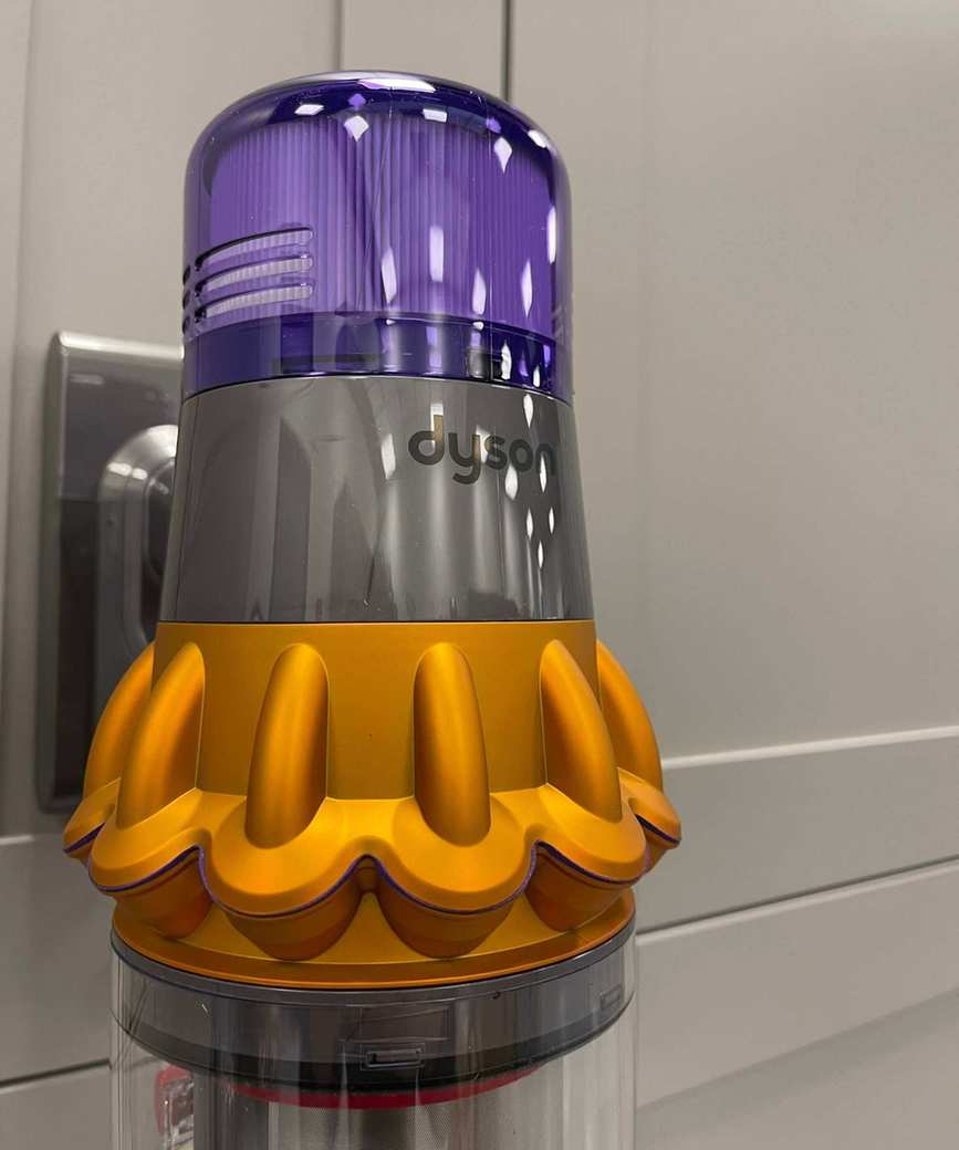 Close up of the main purple and gray vacuum unit of the Dyson V15 Detect