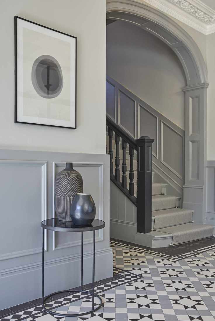 Spacious hallway with grey walls and staircase