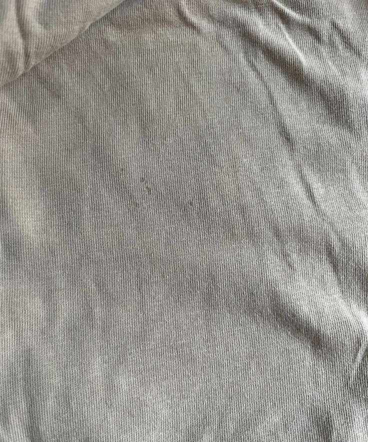 Some old, small blood stains on a beige top
