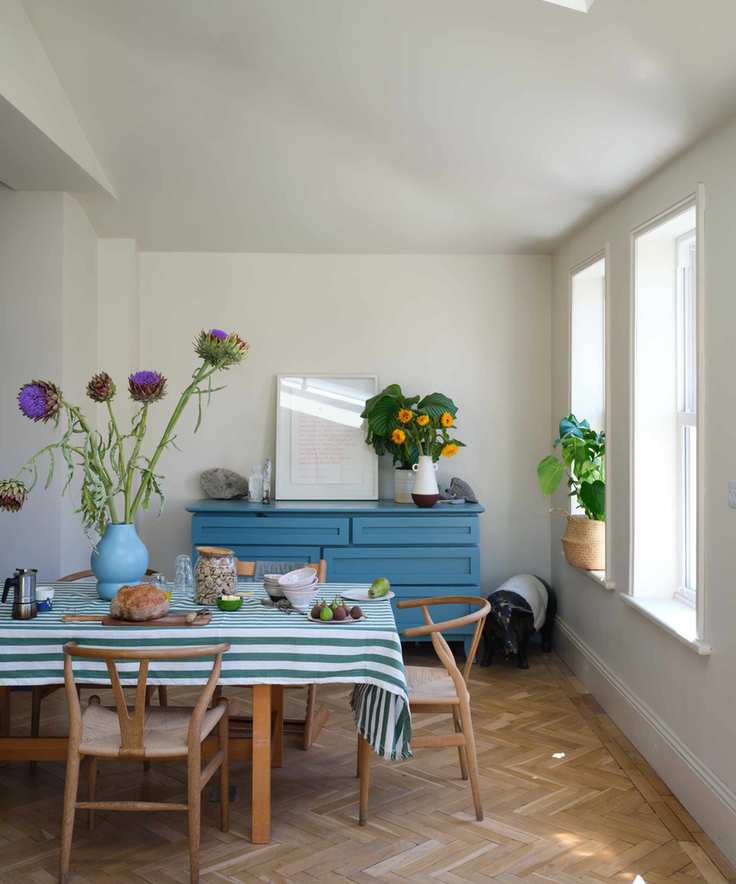 Scandinavian dining room painted in a warm white color