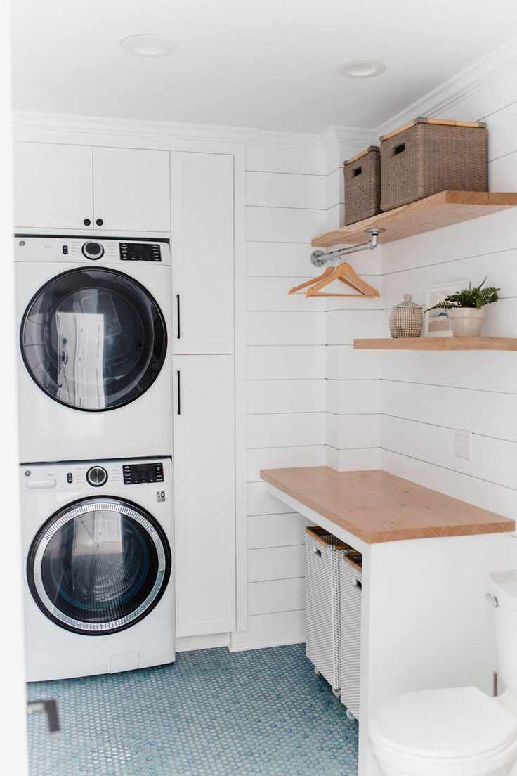 Compact laundry room with white cabinets