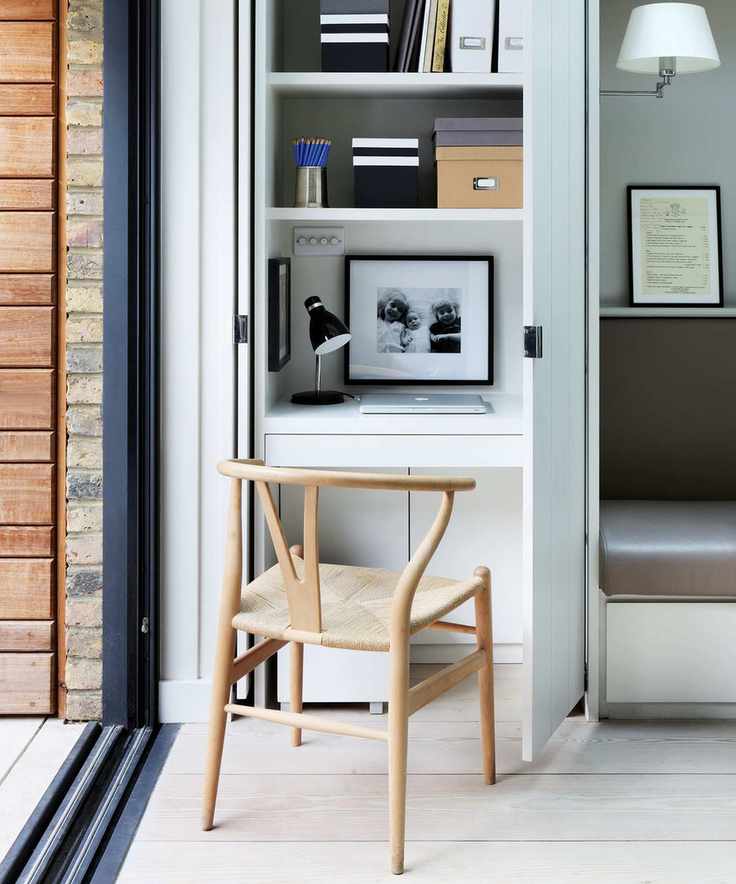 Corner home office with built in shelves and wood Eames chair