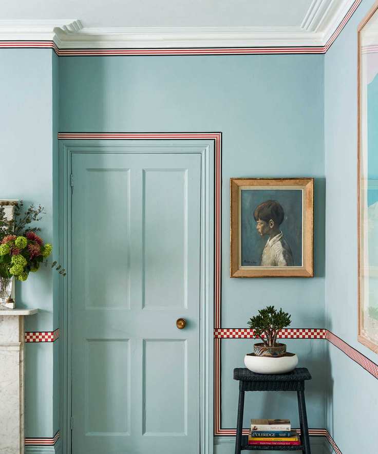 Painted blue hallway with checkered and striped trim