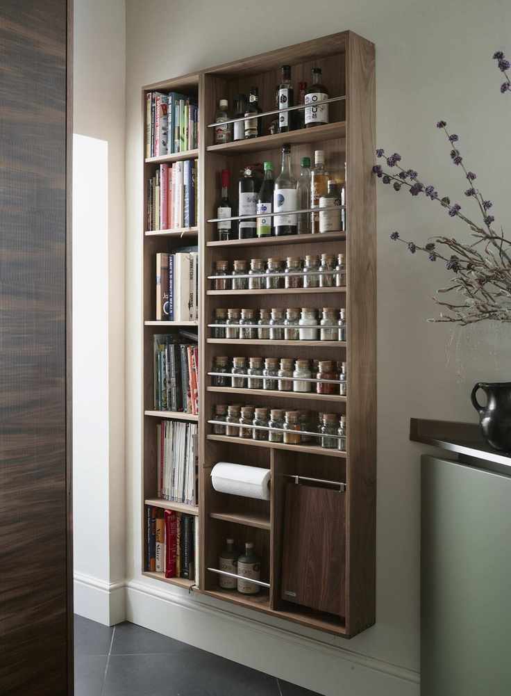 wall-mounted spice storage alongside shelves for drinks and kitchen items