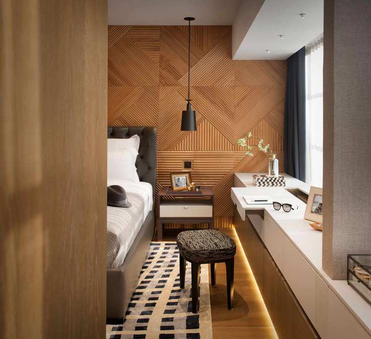 Hidden desks within a wood clad bedroom
