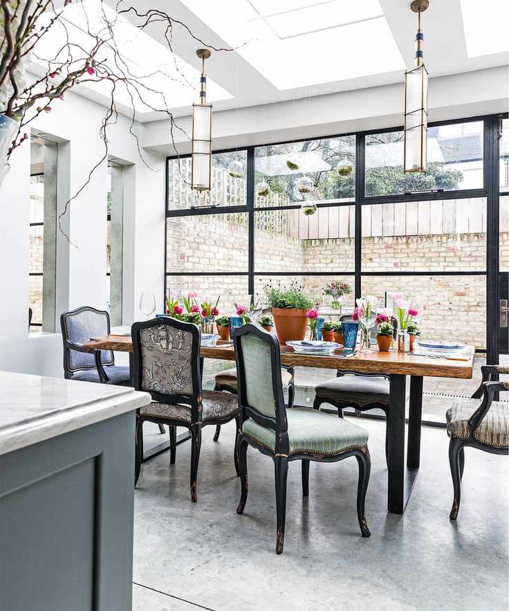 Polished concrete floor beneath a dining table with traditional upholstered chairs.