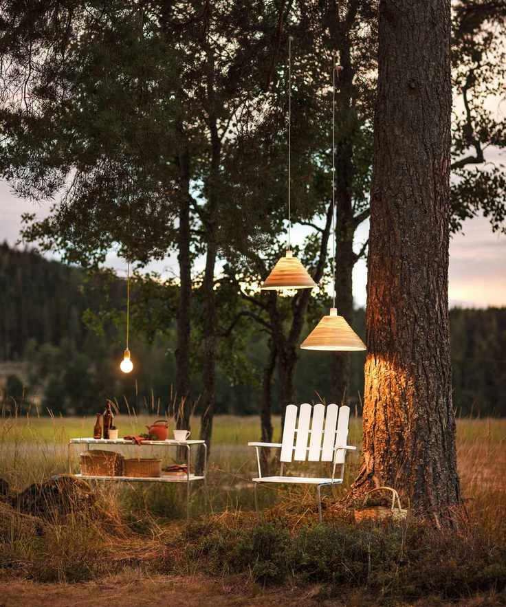 Scandi style garden set-up with garden chair and table, and lighting
