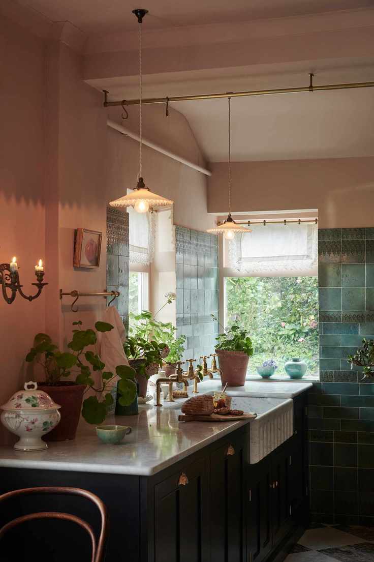 Green tiled wall, black base cabinets