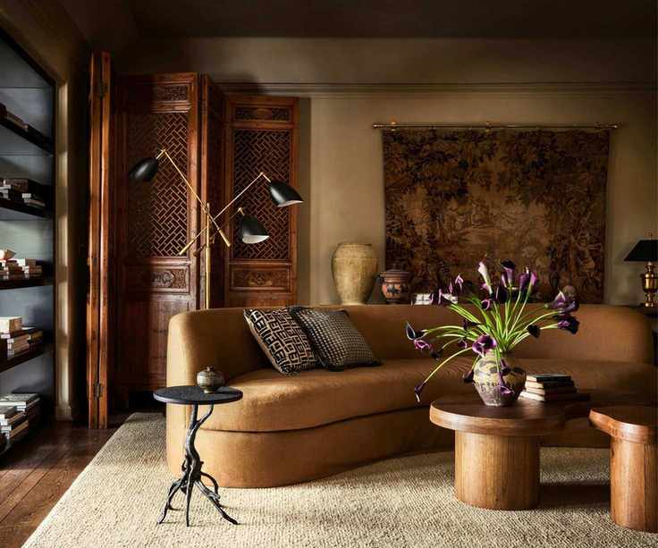 Living room design by Plaster & Patina painted in Riverbed by Dunn Edwards featuring a curved sofa in tan fabric