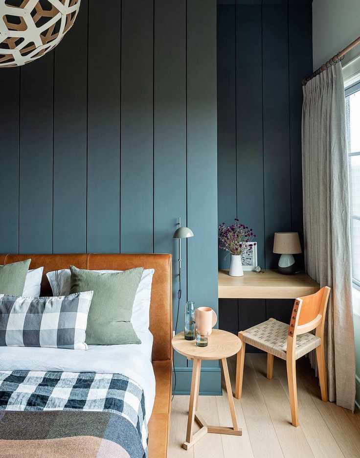 Blue bedroom with a desk in an alcove