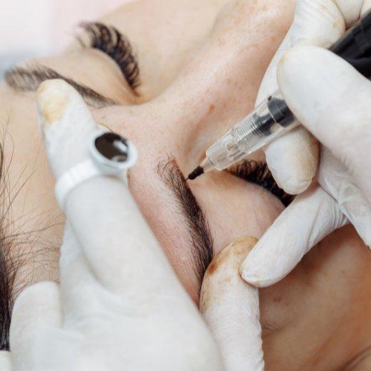 Microblading procedure on eyebrows being done by an eyebrow technician