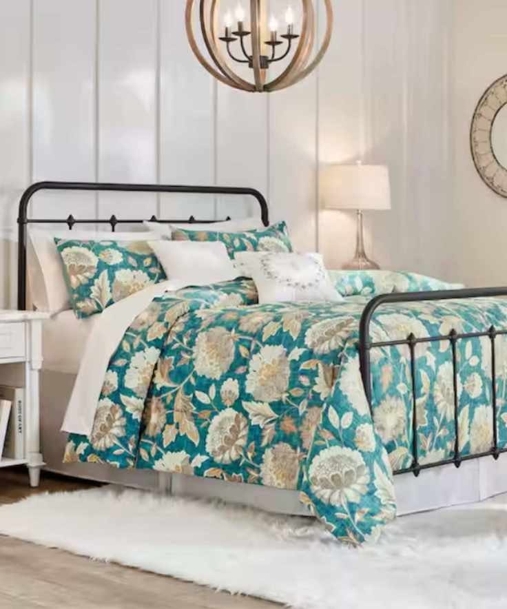 panelled white bedroom with a metal bed frame and teal floral bed linen