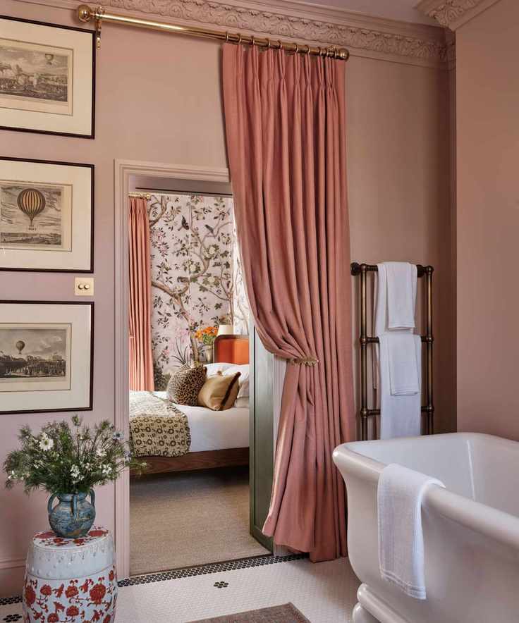 A primary suite with a pink bathroom